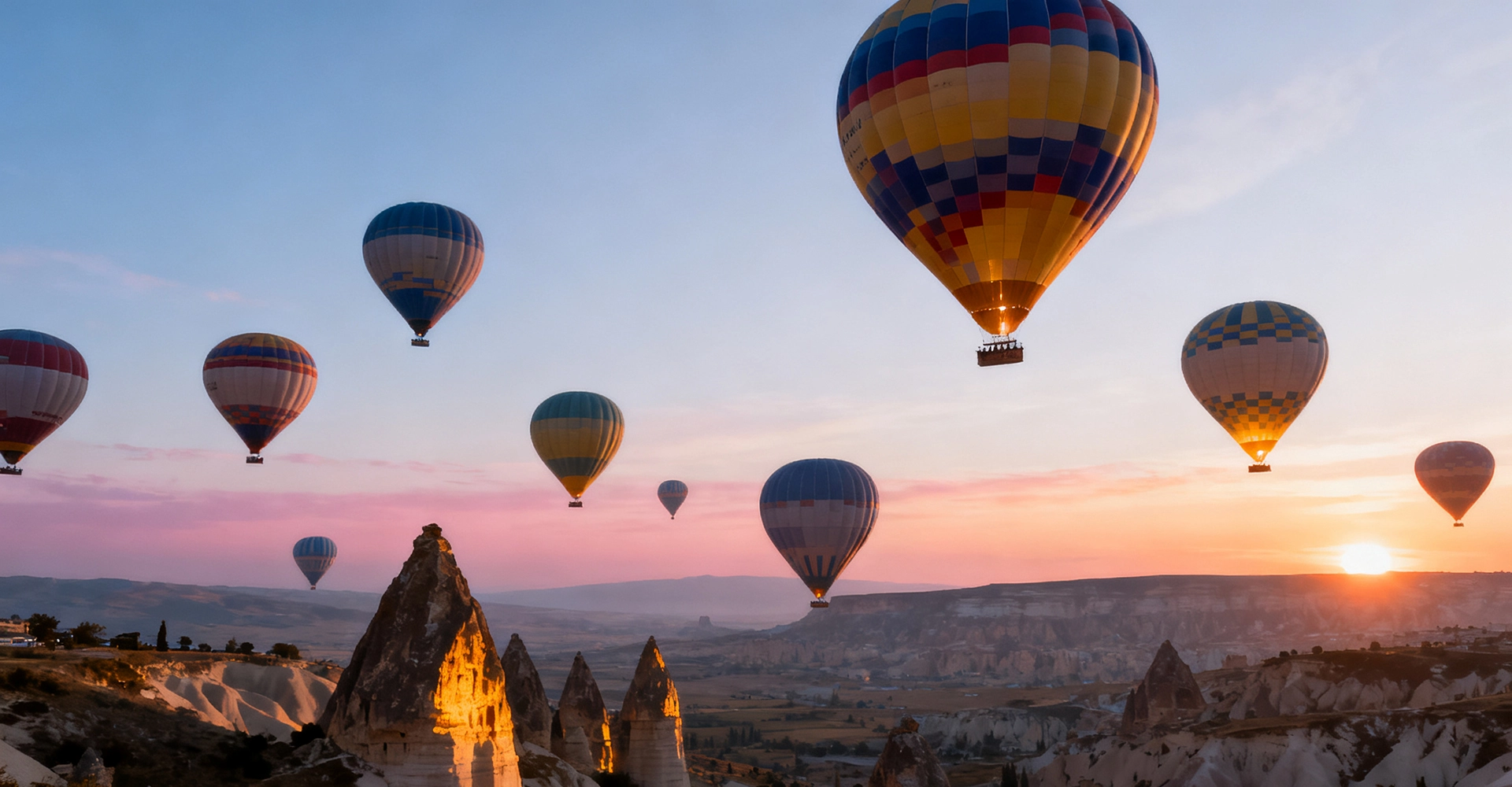 Hot air balloons flying over Cappadocia at sunrise